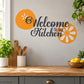 Kitchen wall decal with "Welcome to our Kitchen" text and orange flower accents