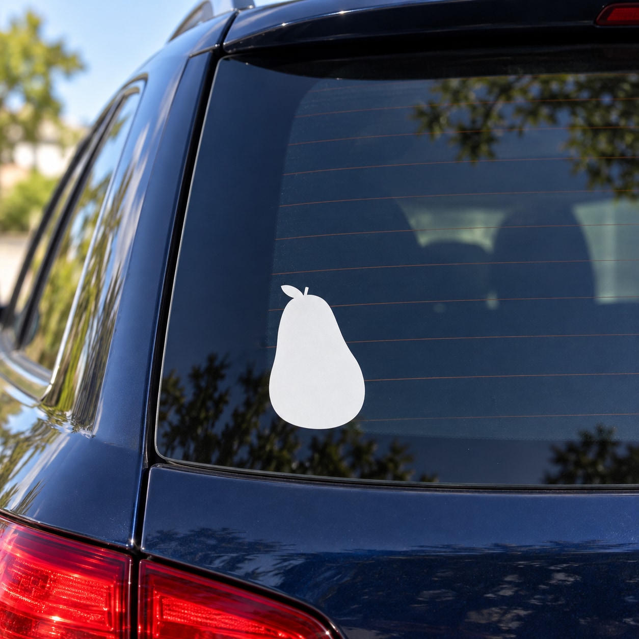 White pear-shaped decal on car rear window, matte vinyl look
