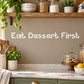 Wall decal with text 'Eat Dessert First' in decorative lettering