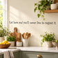 Cursive wall decal quote: “Eat here and you’ll never live to regret it.”