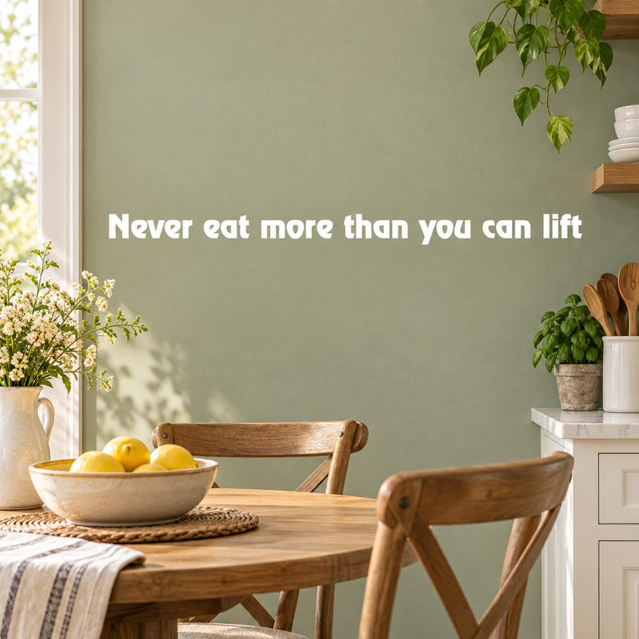 White quote wall decal: 'Never eat more than you can lift'