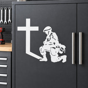 White wall decal of kneeling praying soldier with cross on dark surface