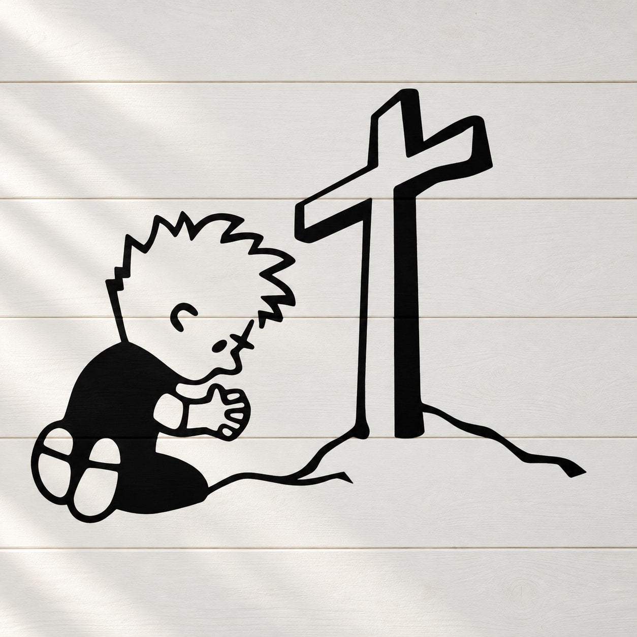 Kneeling boy praying wall decal with large cross and hands clasped, black outline