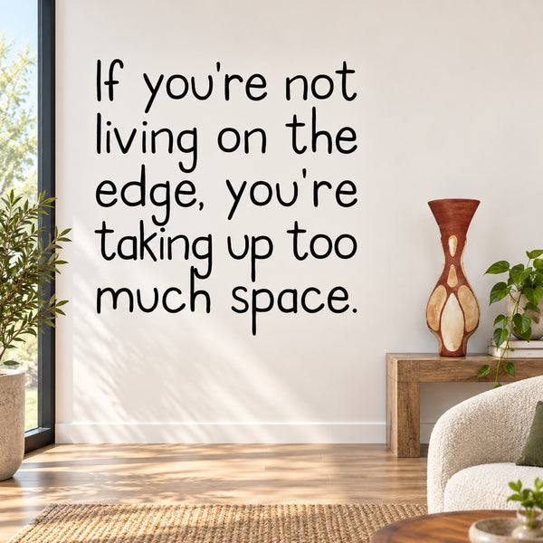 Wall decal with bold black quote: “Not living on the edge, taking up too much space.”
