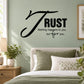 Black wall decal with script text: “Trust nothing happens to you but for you…”