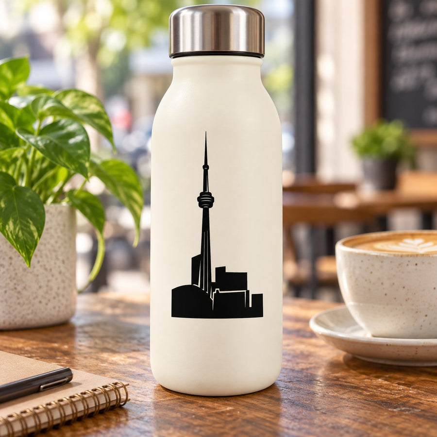 Cream travel water bottle with black Toronto skyline decal, tall tower silhouette.