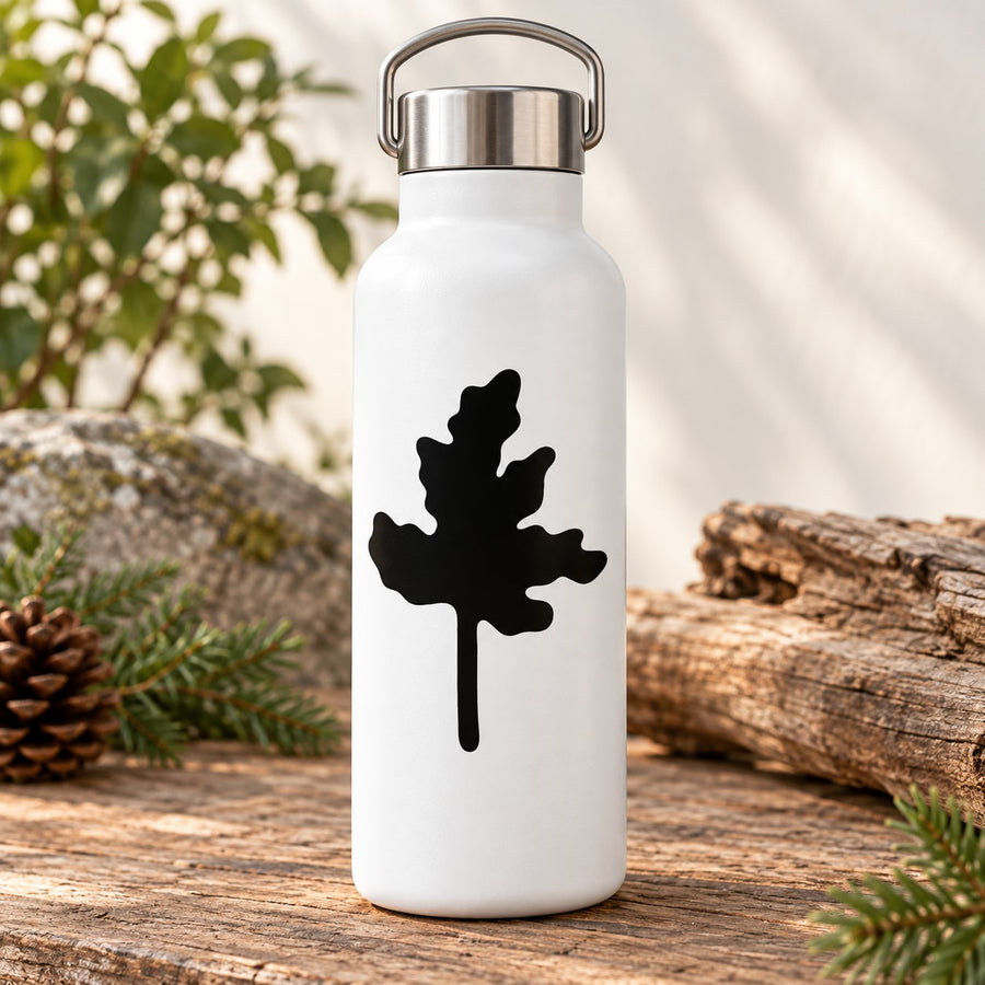 Black tree silhouette vinyl wall decal applied on a white bottle