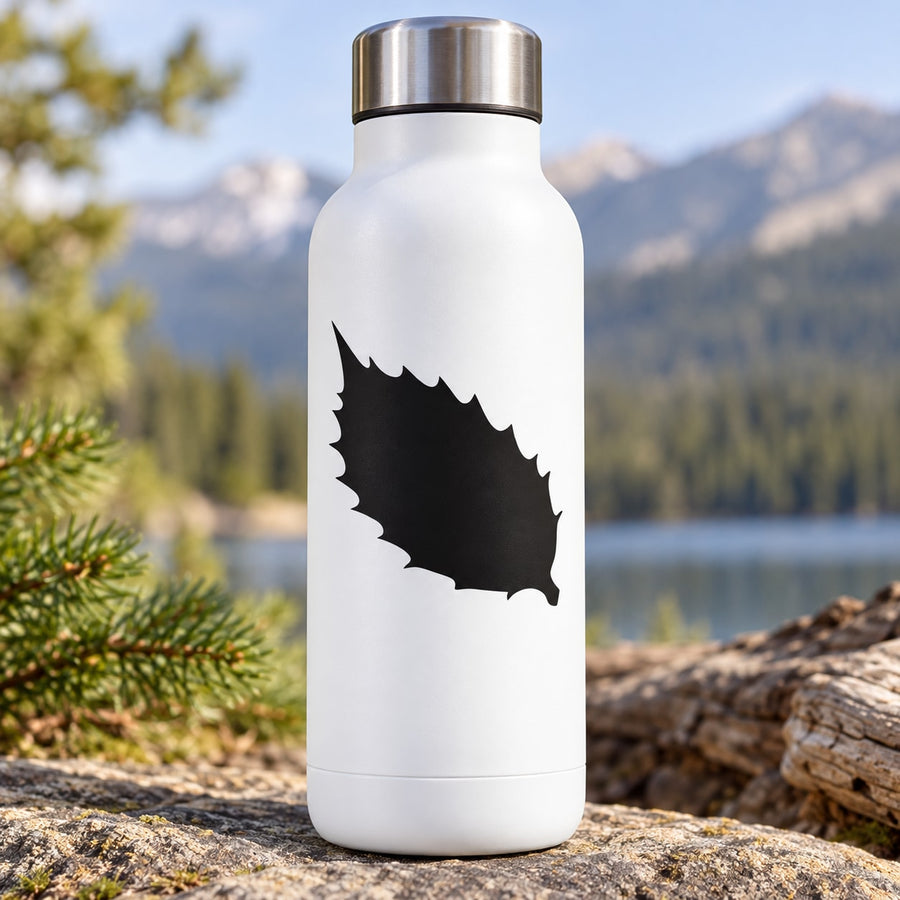 Black leaf-shaped decal on a white bottle