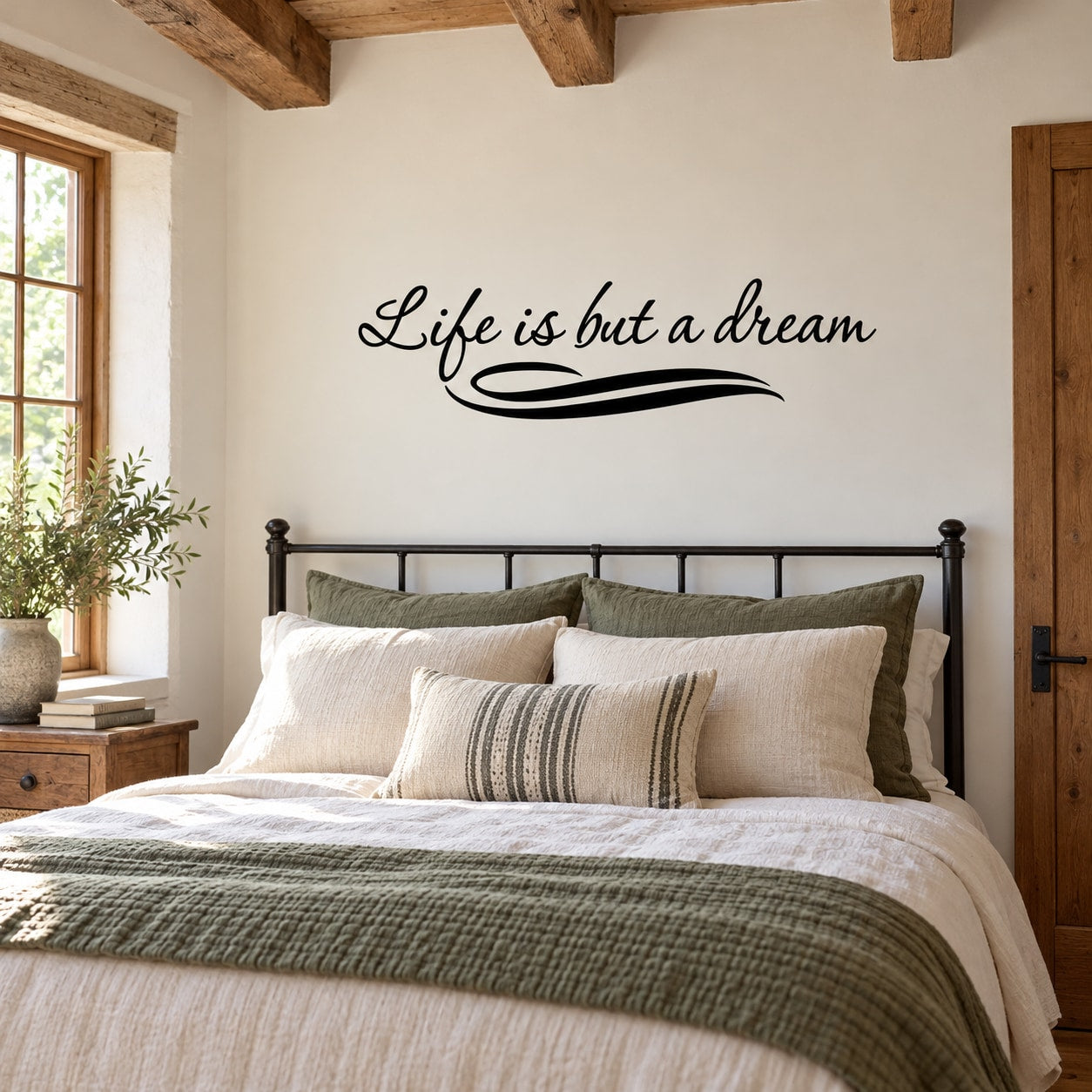 Wall decal with cursive quote “Life is but a dream” in black script