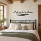 Wall decal with cursive quote “Life is but a dream” in black script