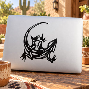 Black stylized lizard outline decal on laptop lid