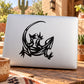 Black stylized lizard outline decal on laptop lid