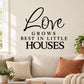 Black wall decal with 'Love grows best in little houses' lettering