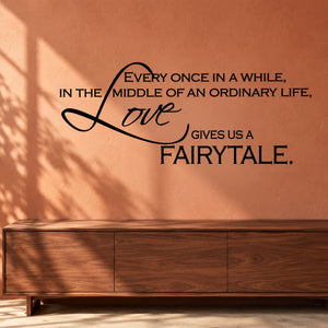 Wall decal with black quote and cursive 'Love' lettering, 'fairytale' at bottom
