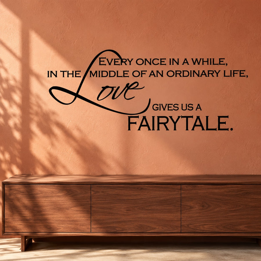 Wall decal with black quote and cursive 'Love' lettering, 'fairytale' at bottom