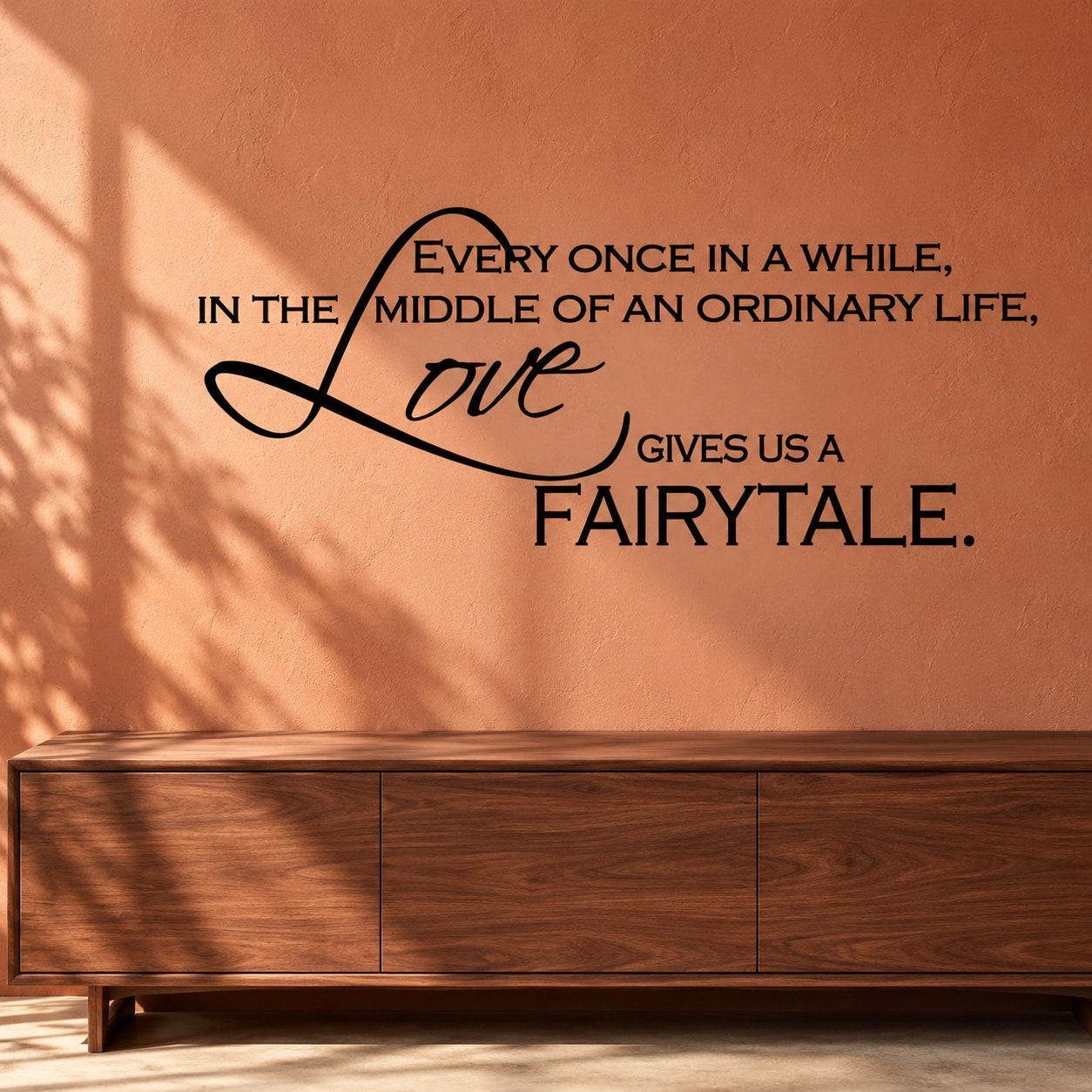 Wall decal with black quote and cursive 'Love' lettering, 'fairytale' at bottom