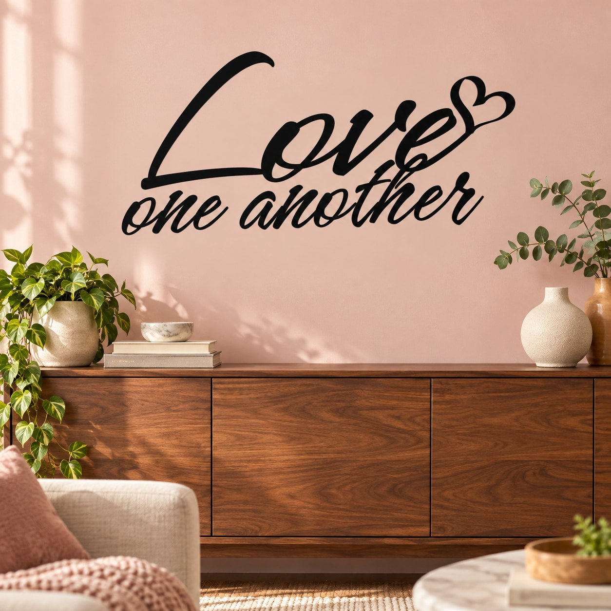 Love one another wall decal with black cursive script and heart over text