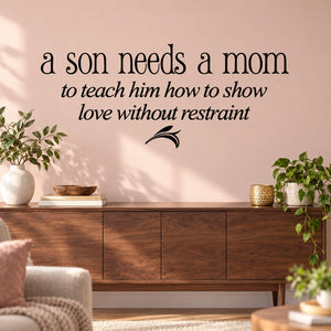 Wall quote decal: 'a son needs a mom' and 'love without restraint' with small wing icon