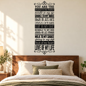Love word collage wall decal with ornate border, script quotes on a dark background