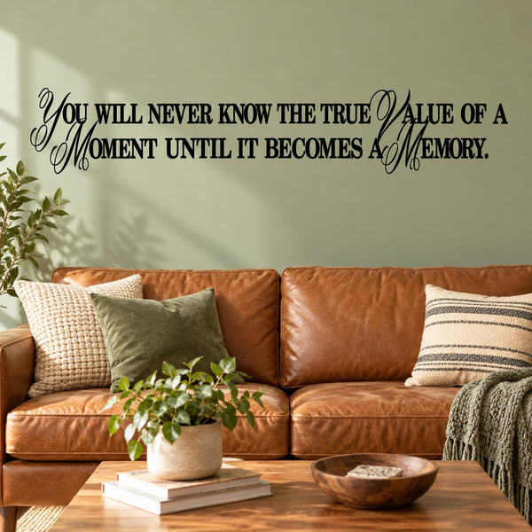 Wall decal with black cursive quote about the value of a moment becoming a memory