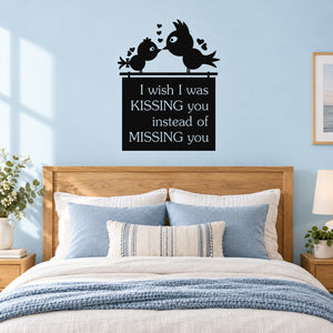 Black wall decal of two birds with hearts, quote: “kissing you instead of missing you”