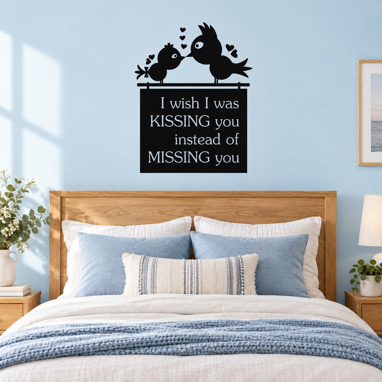 Black wall decal of two birds with hearts, quote: “kissing you instead of missing you”