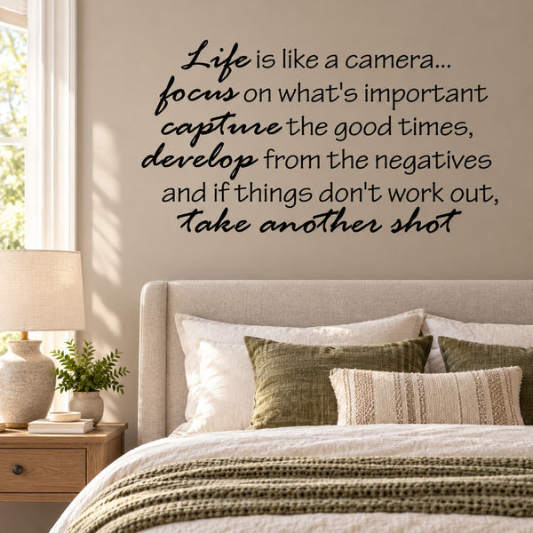 Wall decal with black cursive motivational quote text on a light wall