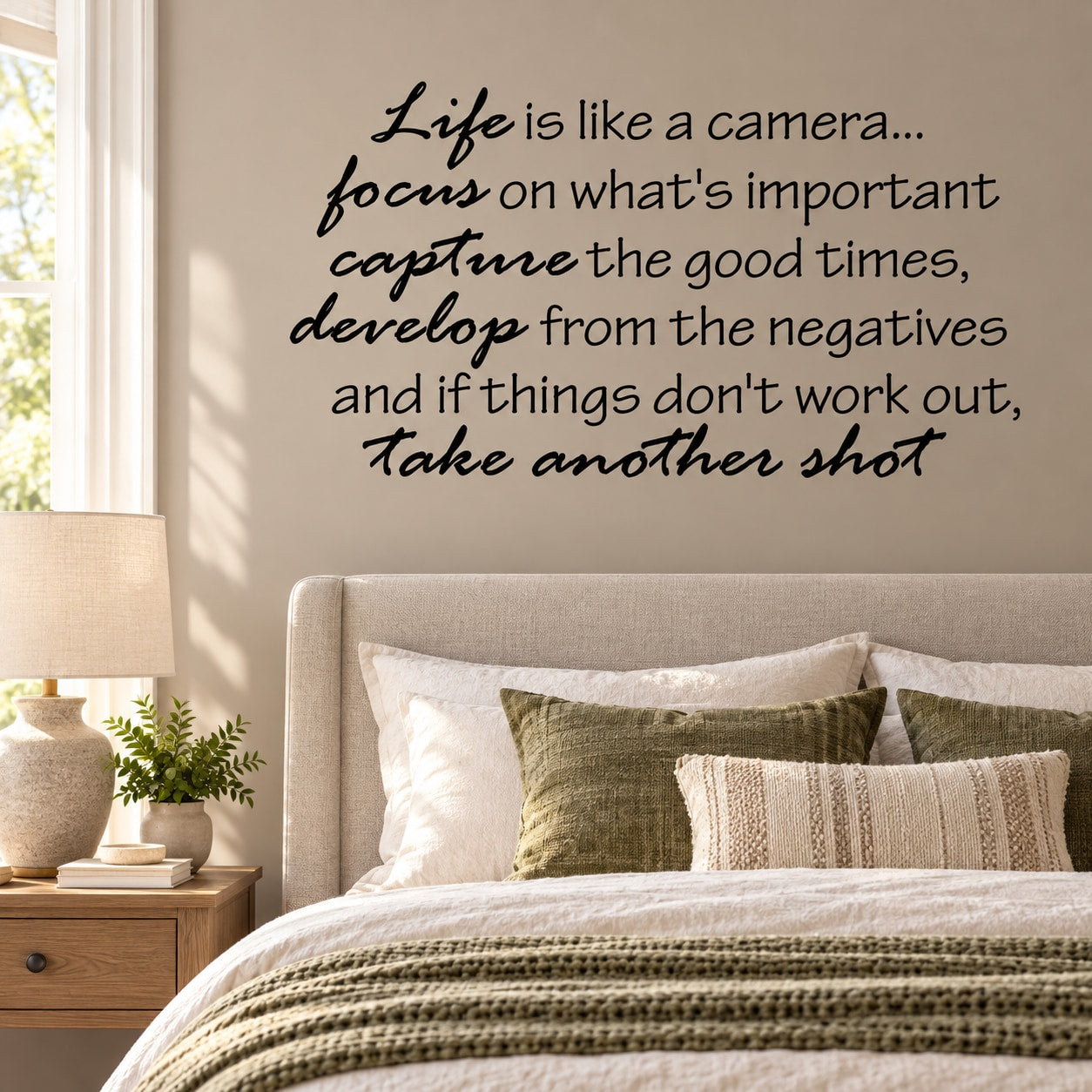 Wall decal with black cursive motivational quote text on a light wall