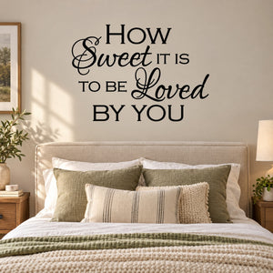 Wall decal text: "How Sweet It Is to Be Loved by You" in black script.