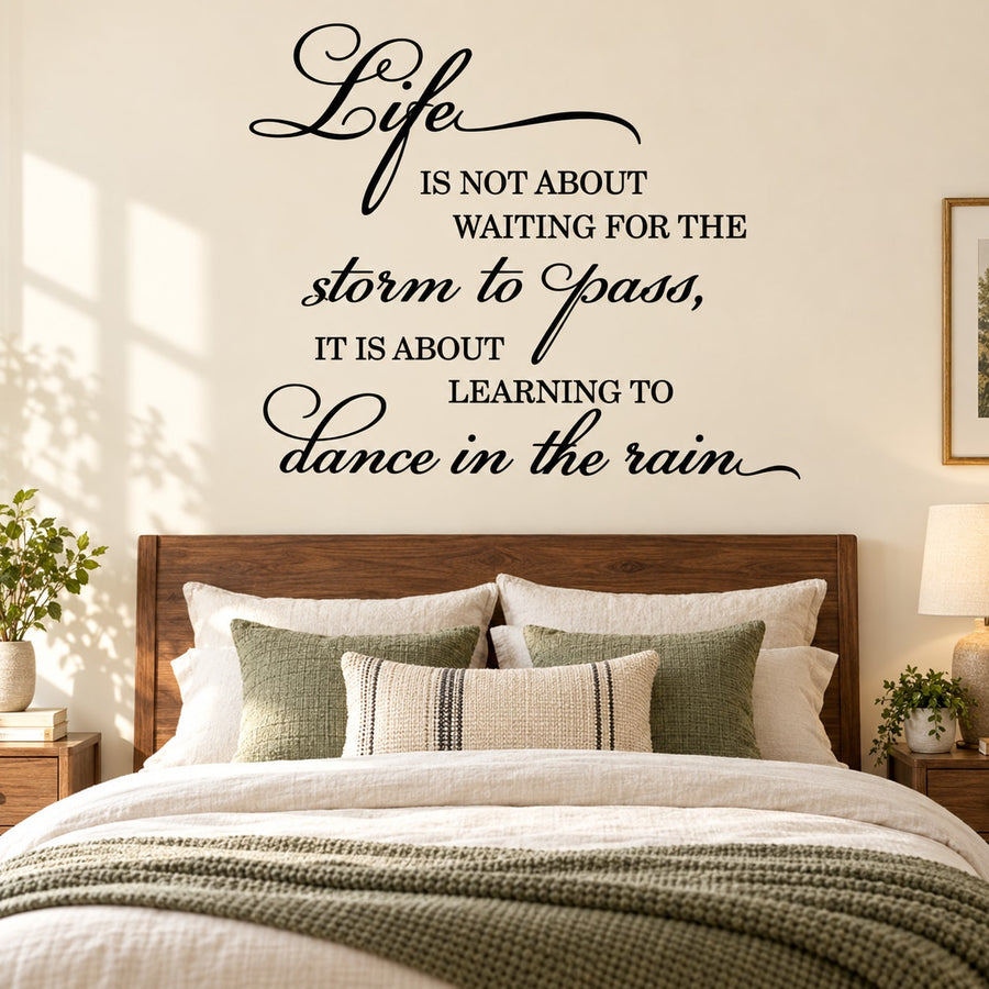 Inspirational wall decal quote in black cursive: dance in the rain