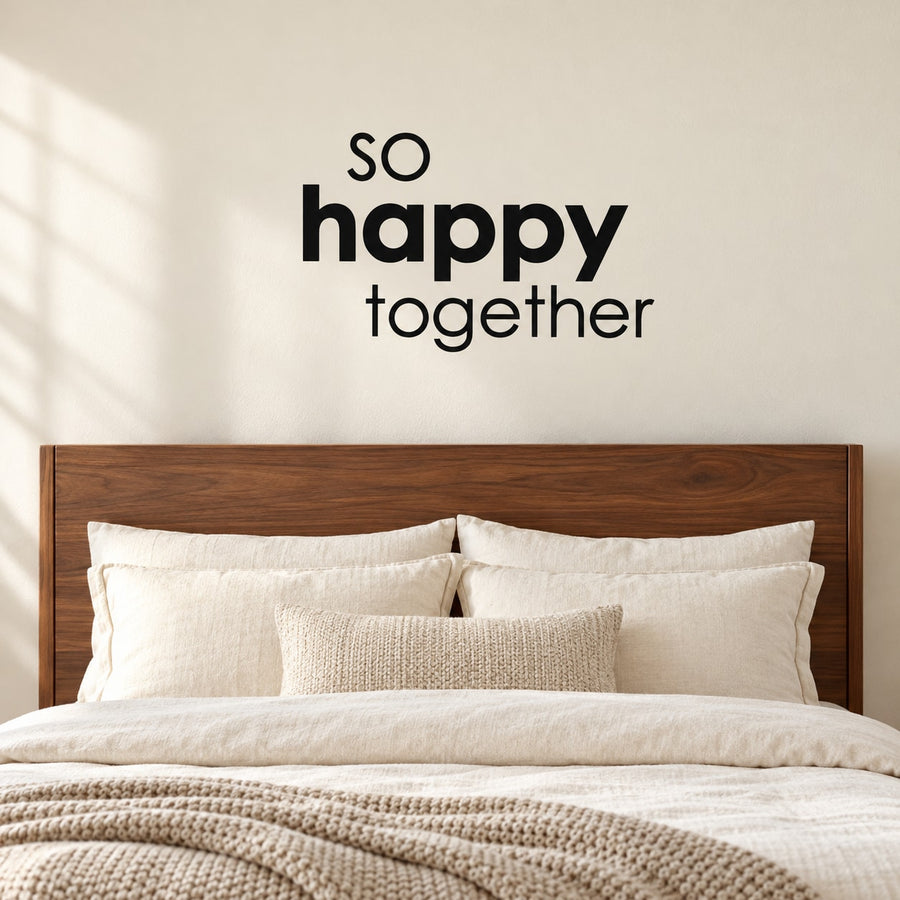 Wall decal reading "So happy together" above bed