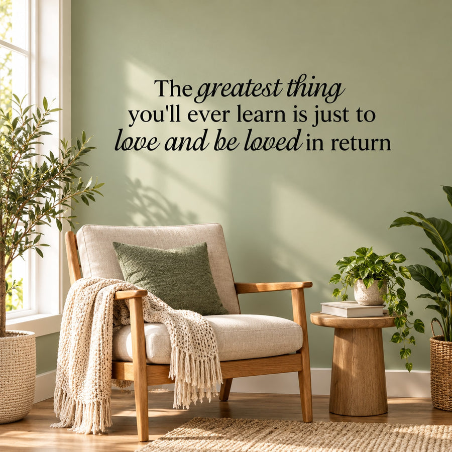 Cursive wall decal quote: 'love and be loved in return'.