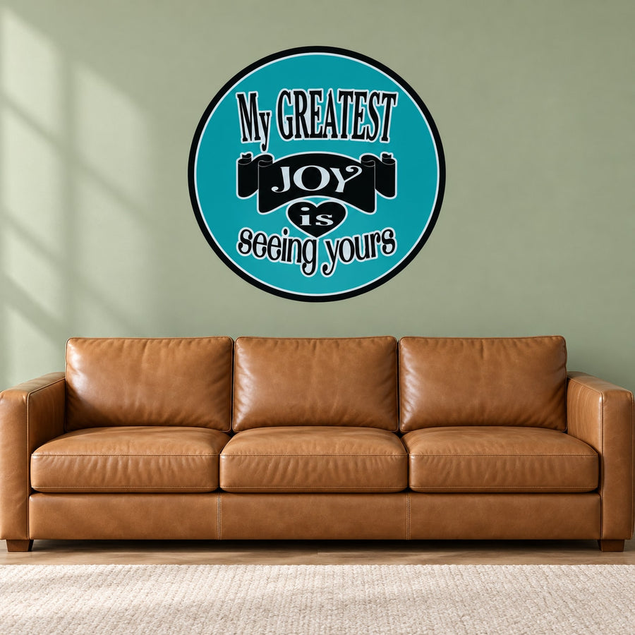 Round teal quote sticker with black border, text: 'My greatest joy is seeing yours'