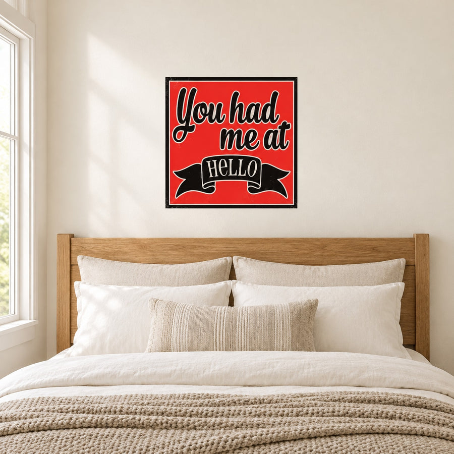 Red quote sticker with “You had me at HELLO” in white script