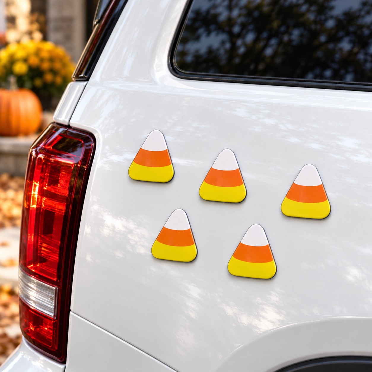 Candy corn magnets: five small white, orange, and yellow triangle pieces on a vehicle