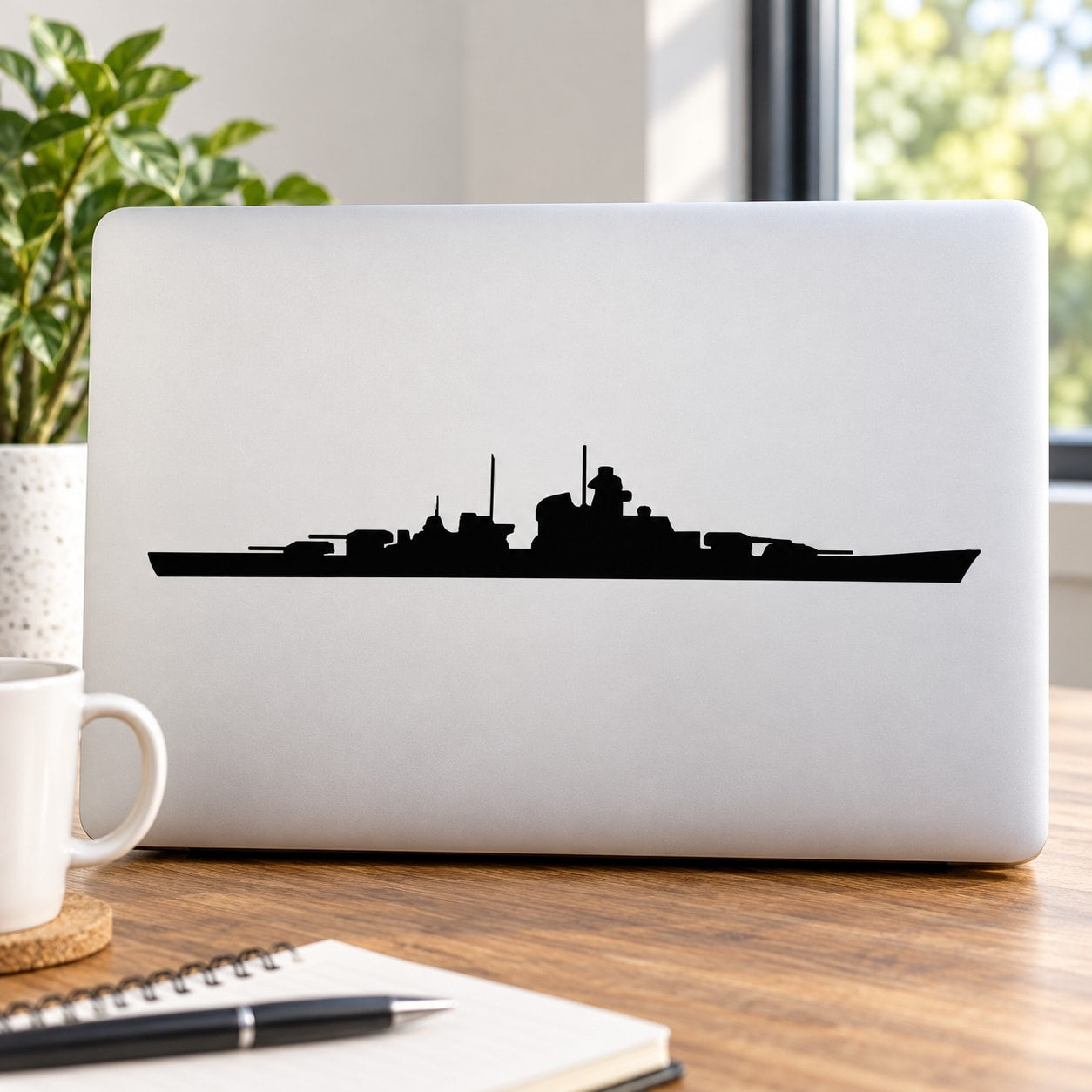 Black battleship silhouette decal on white laptop lid
