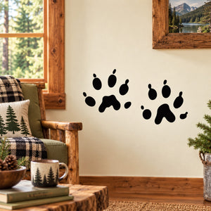 Black pet paw track decal with multiple paw prints on a light wall