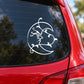 White circular moon decal with stylized creature and vine accents on car window