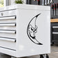 Frightful moon decal with black crescent-and-face design on white surface