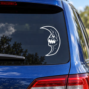 Demon face moon car decal, white outline skull on crescent moon on rear window