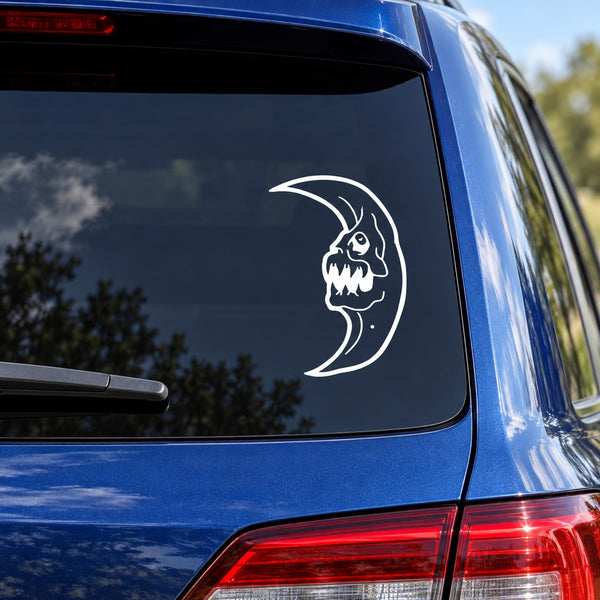 Demon face moon car decal, white outline skull on crescent moon on rear window