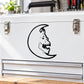 Moon creature decal with black face on crescent moon on a white surface
