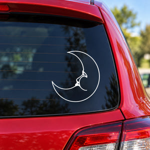 White moon-phase dreaming decal with crescent outline on car window