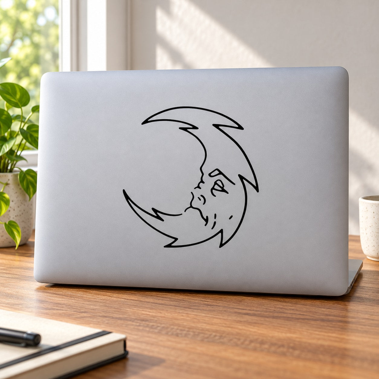 Spiky crescent moon decal with cute sleeping face, black outline design