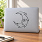 Spiky crescent moon decal with cute sleeping face, black outline design