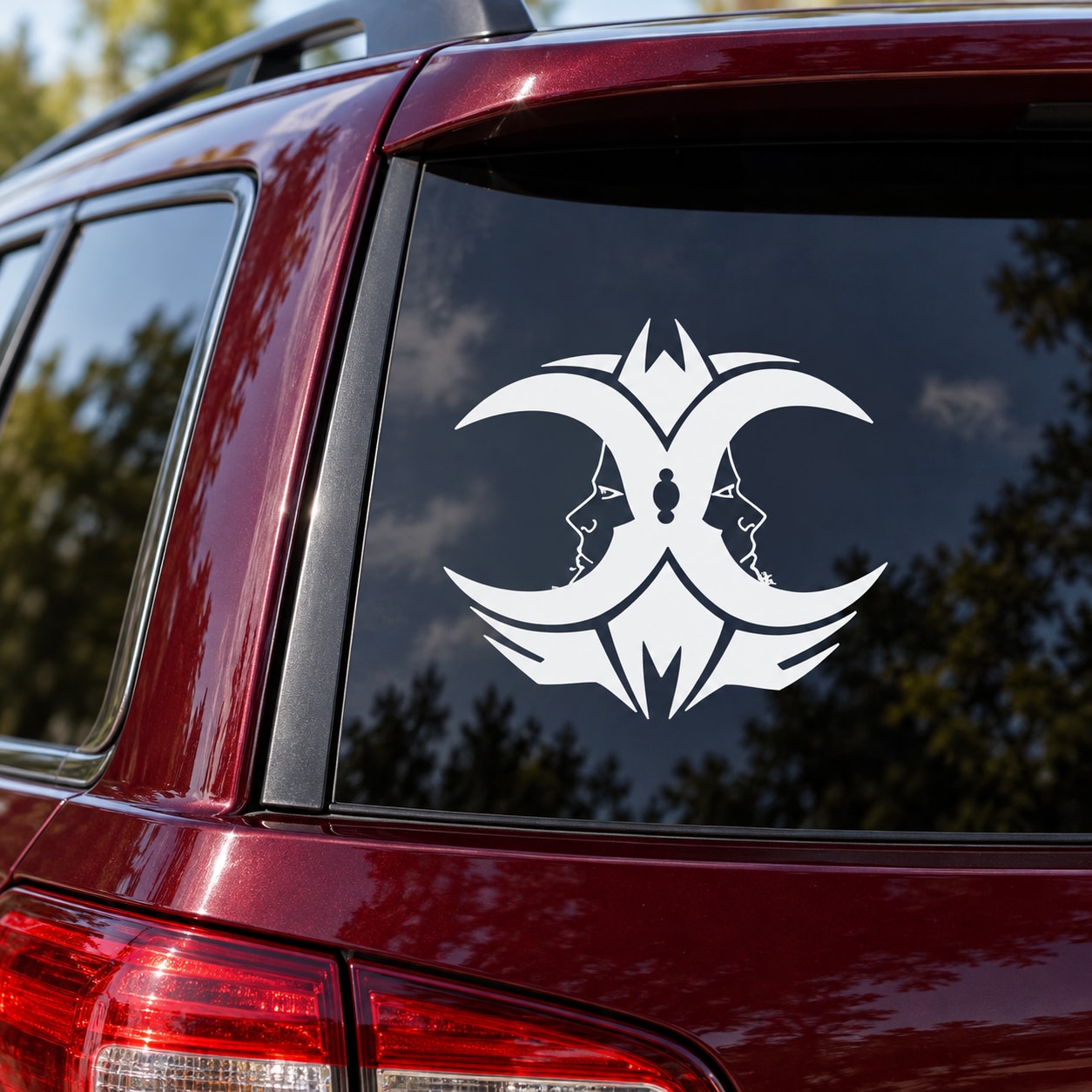 White two-moon decal with symmetrical wolf faces on car rear window