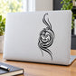 White laptop with black decorative full moon face line art graphic
