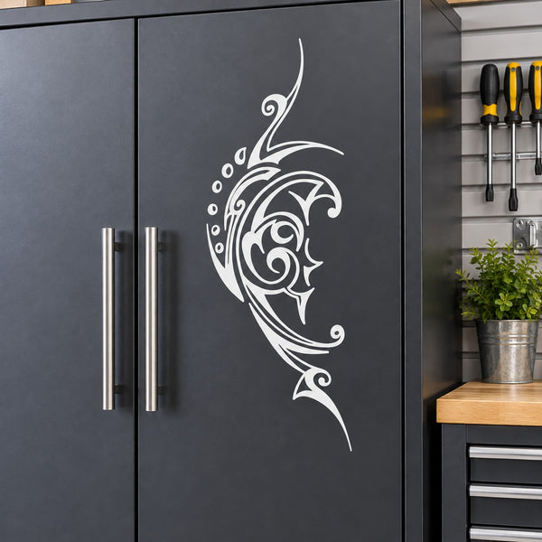White moon face decorative vinyl decal with swirling filigree design on a cabinet door