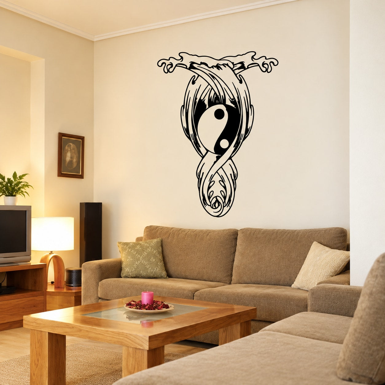 Black and white yin-yang moon and wave wall decal, centered on wall above couch