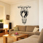 Black and white yin-yang moon and wave wall decal, centered on wall above couch